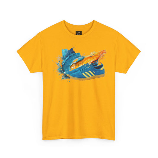 A bright yellow short-sleeve crewneck t-shirt featuring a graphic print of a blue sneaker surrounded by blue and orange paint splatters on the chest, displayed against a solid white background.