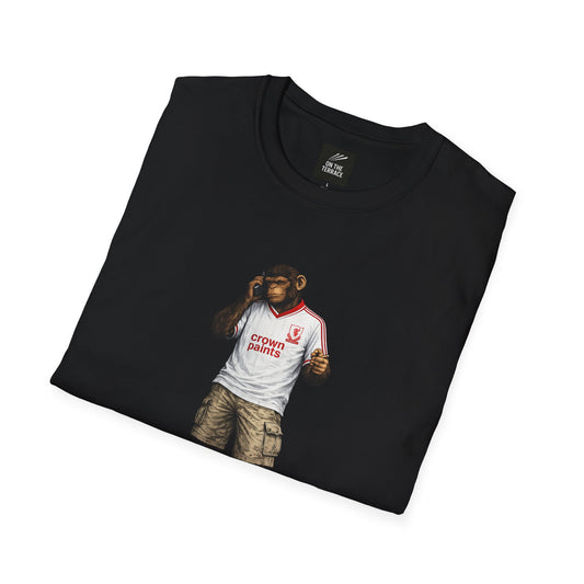 A folded black t-shirt featuring a graphic of a chimpanzee dressed as a LIVERPOOL fan. The chimp is wearing a retro 1990s-style away kit, cargo shorts, and blue trainers. He is depicted smoking a cigarette and talking on a vintage mobile phone.