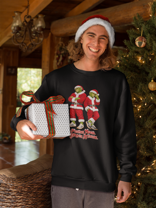 Man in a Santa hat holding a gift, wearing Northern Monkeys Festive Mood Terrace Attitude jumper