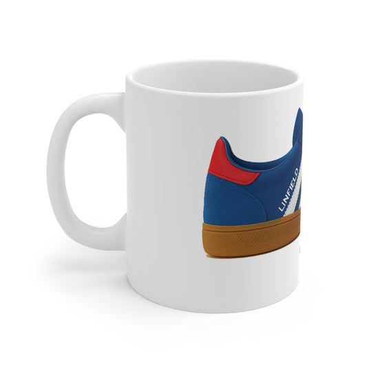 White ceramic coffee mug featuring a blue, red, and gum sole sneaker graphic