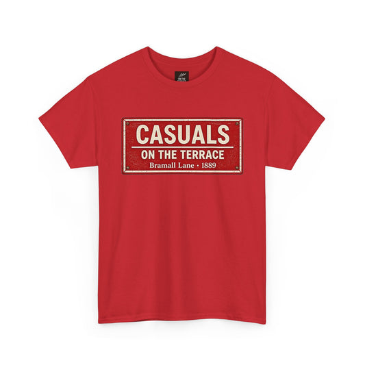 A red short-sleeve SUFC t-shirt featuring a distressed vintage-style street sign graphic on the chest that reads 'CASUALS ON THE TERRACE Bramall Lane - 1889'.