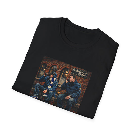 Folded black t-shirt with graphic design of two people sitting on a bench in a city street.