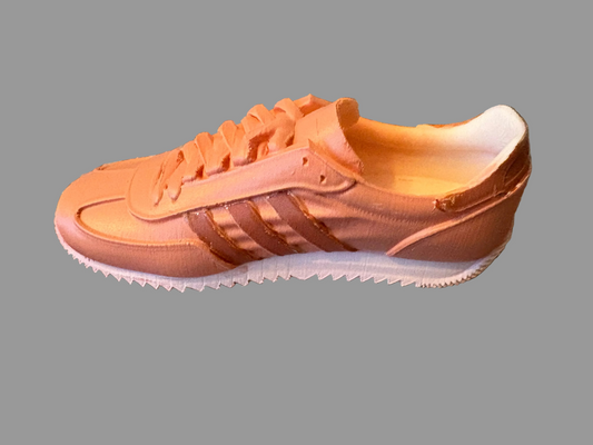 LG Adidas sneaker on a textured surface