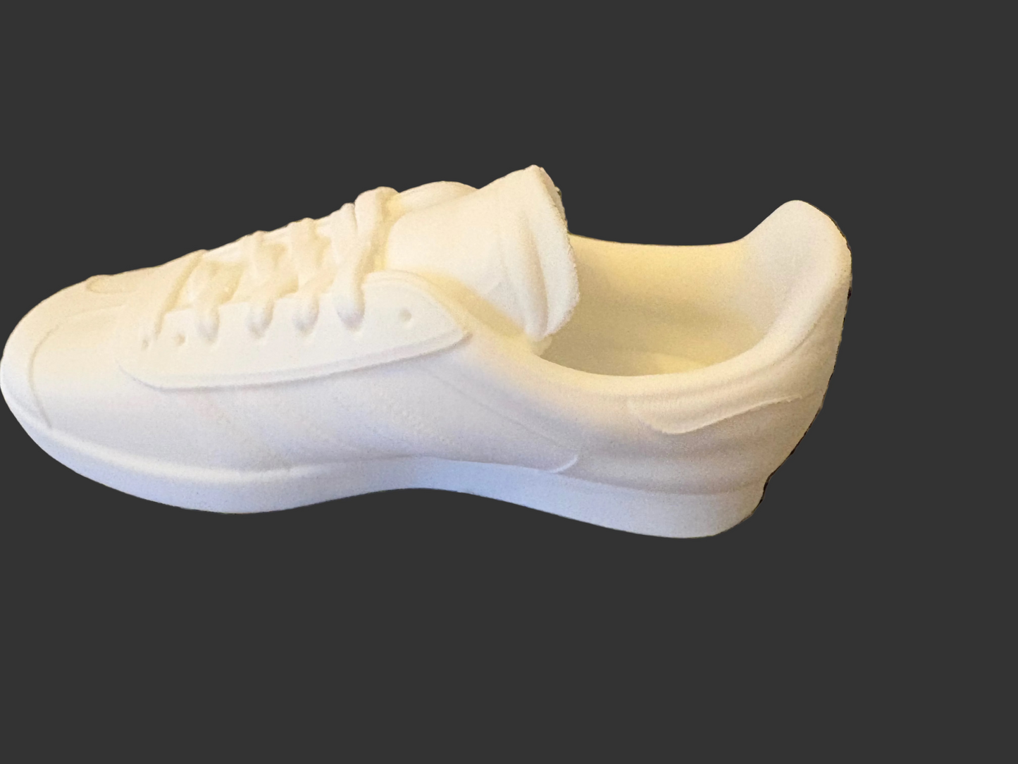 White Adidas Gazelle 3d printed sneaker on a textured gray surface
