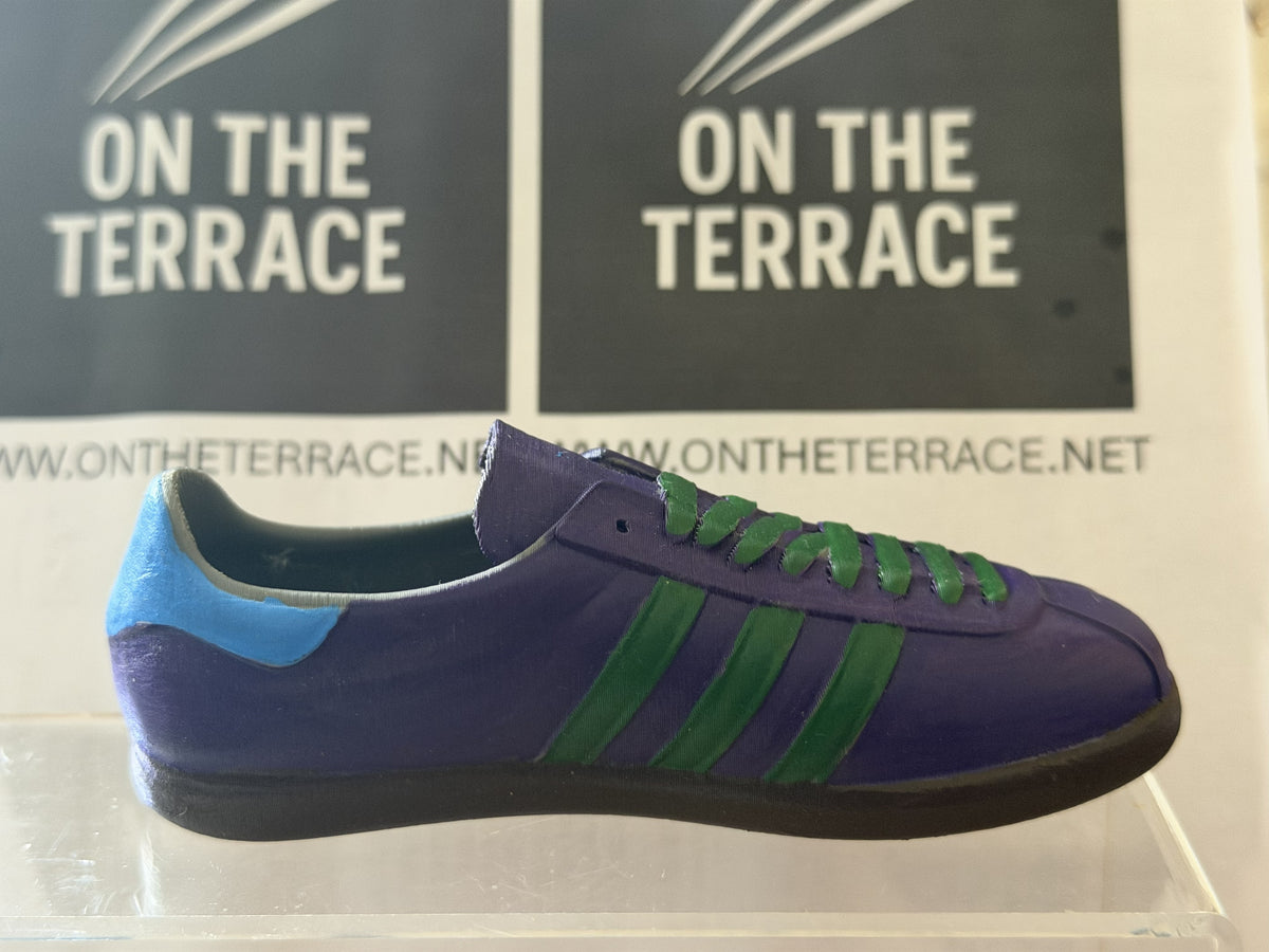 adidas Napoli inspired 3D printed trainer model, side view in purple and green on a clear display stand