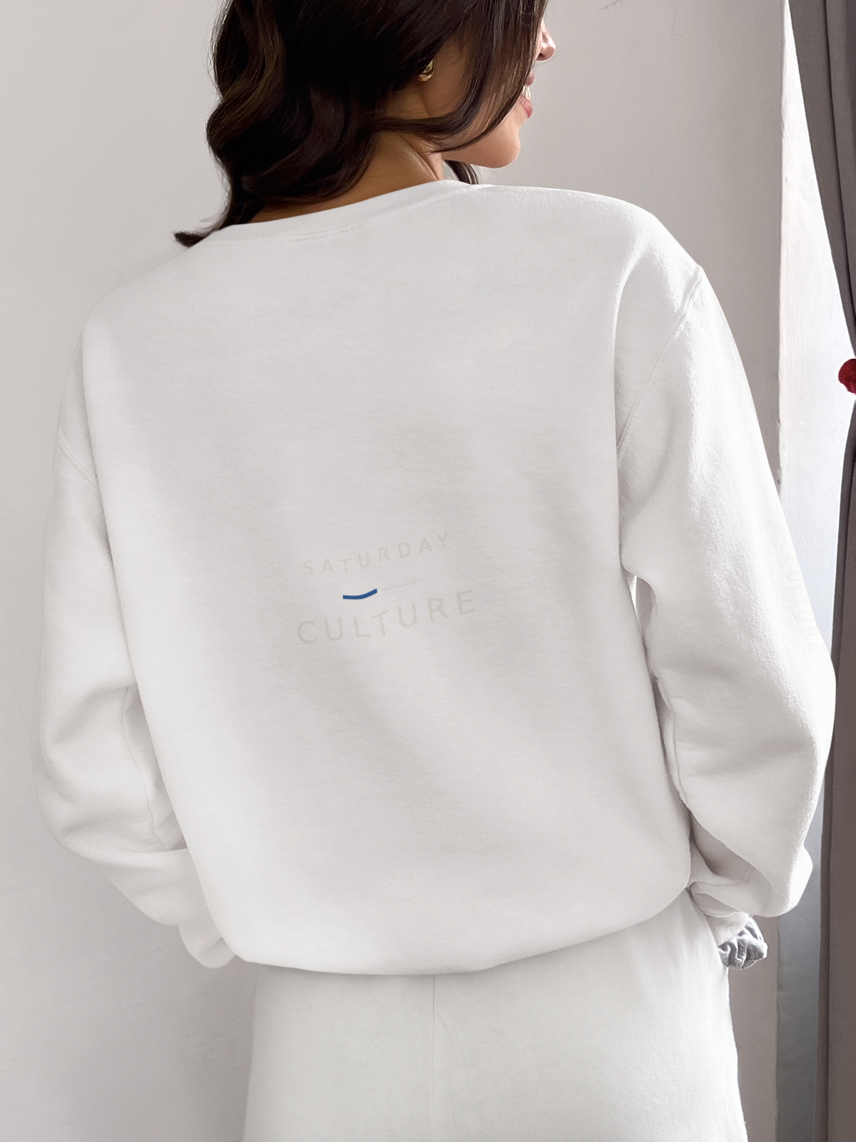 Back view of a woman wearing the white Style Before Kick-Off sweatshirt