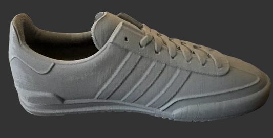 Gray adidas sneaker with 'JEANS' branding on a textured surface