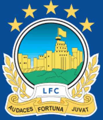 Football club style badge with a cityscape, five stars, shield, and laurel wreath design.