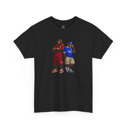 A black short-sleeve Ipswich t-shirt featuring a graphic print of two men standing side-by-side. The man on the left wears a red jersey and shorts, while the man on the right wears a blue jersey and khaki shorts.