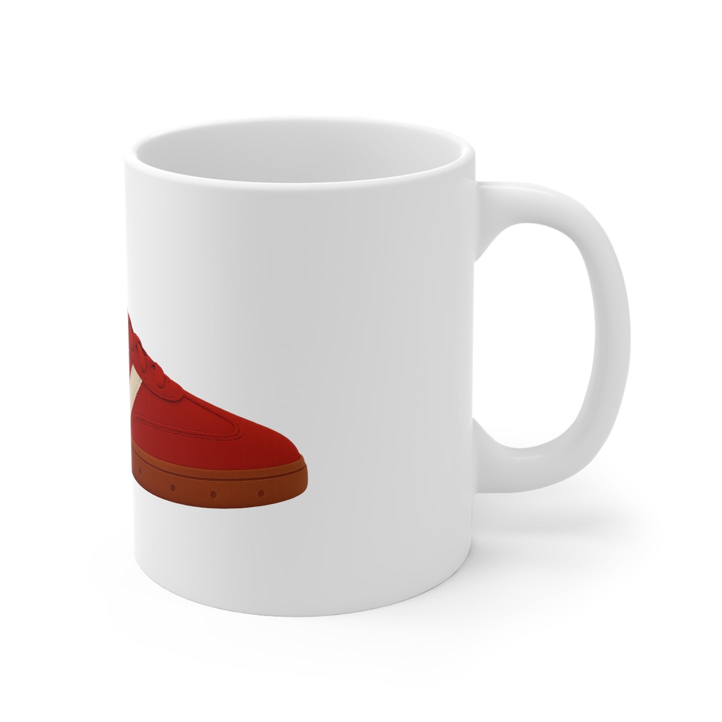 White ceramic mug with a red sneaker illustration and brown sole on the side