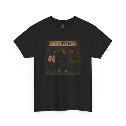 A black short-sleeve crewneck Luton t-shirt featuring a square graphic print on the chest with the word 'LUTON' above an illustration of three men sitting on a bench.