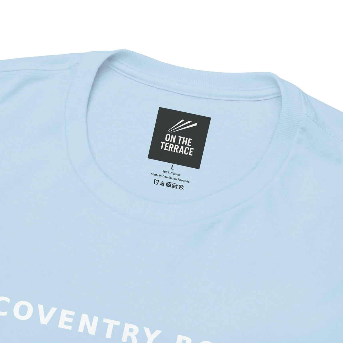 Close-up of the neck label and COVENTRY BOYS print on the sky blue tee