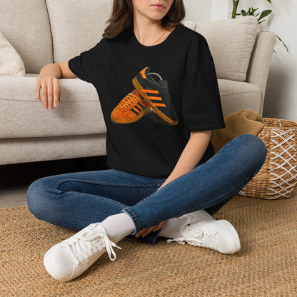 Black t-shirt with orange retro sneaker graphic print showing detailed side and sole view
