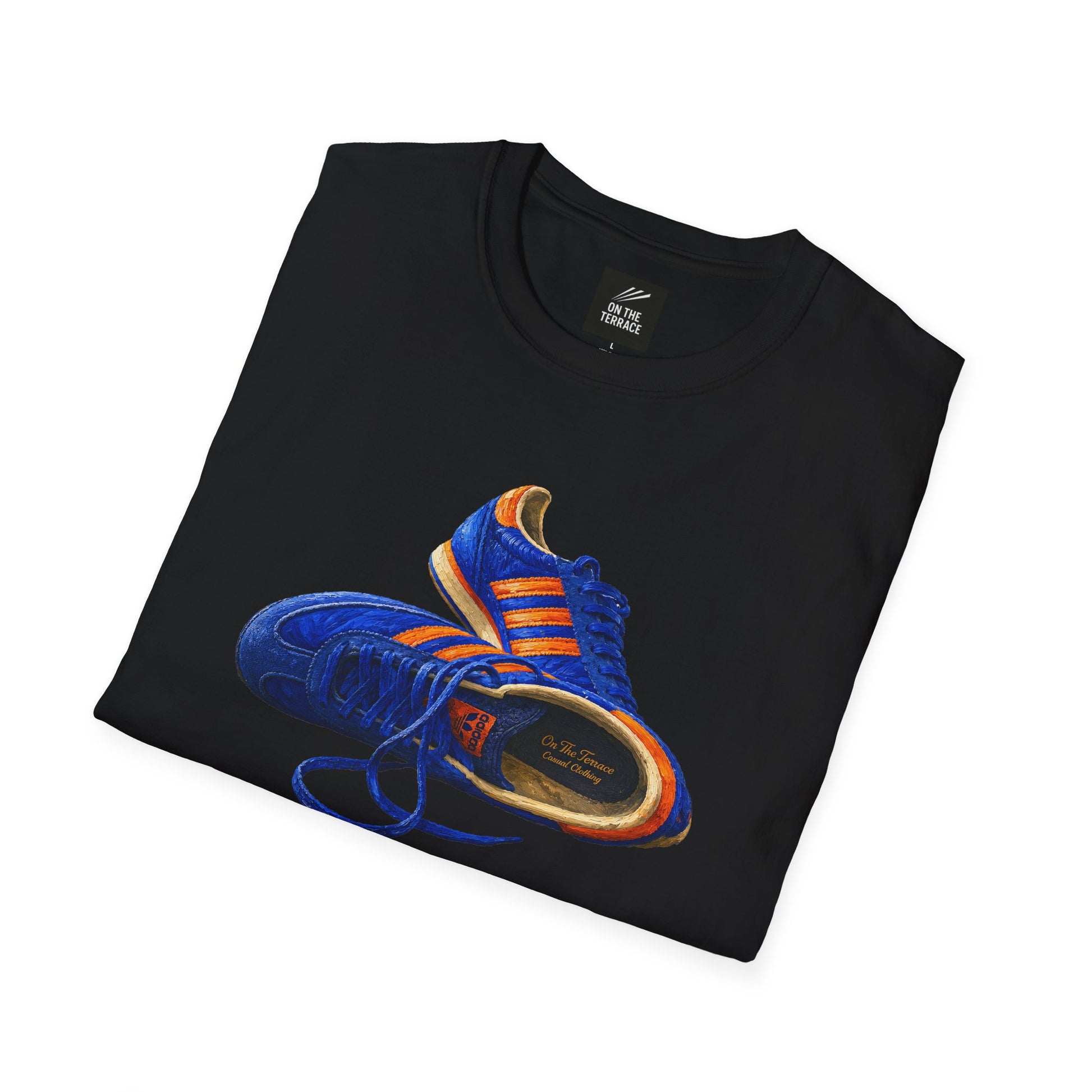 A black folded t-shirt with hand-illustrated blue and orange retro terrace trainer sneaker graphic print, On The Terrace casual clothing brand
