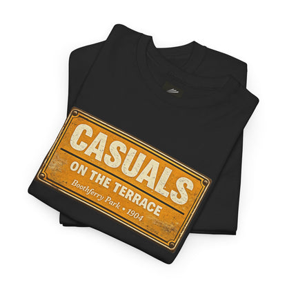 A folded black HULL CITY t-shirt with a vintage-style orange and white street sign graphic reading 'CASUALS ON THE TERRACE' and 'Boothferry Park * 1504'.