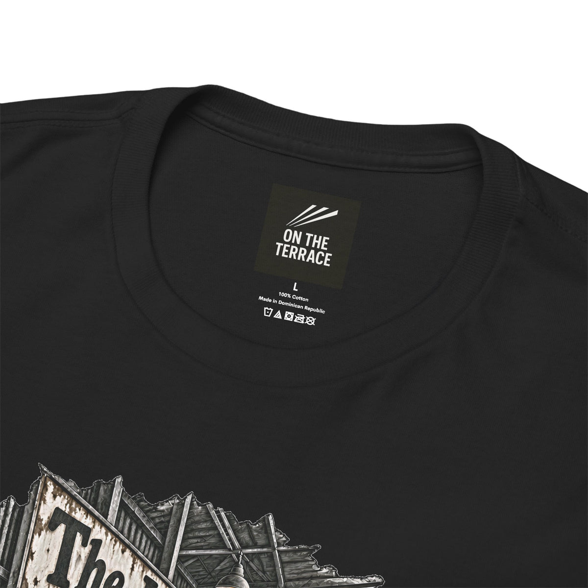 Close-up of On The Terrace neck label and distressed print on black heavy cotton tee