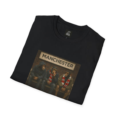 Folded black MUFC northern monkeys t-shirt with 'manchester' text and graphic on a white background