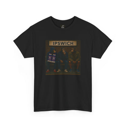 A black short-sleeve Ipswich t-shirt featuring a rectangular graphic print on the chest. The graphic shows three hooded figures sitting on a bench in front of a sign that reads 'IPSWICH'.