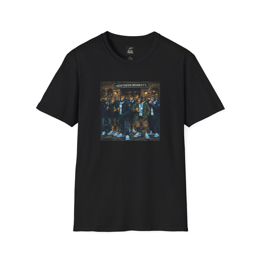 Black t-shirt with a graphic of chimpanzees dressed as Manchester City fans in scarves and parkas standing outside a pub called "The Northern Monkey's."