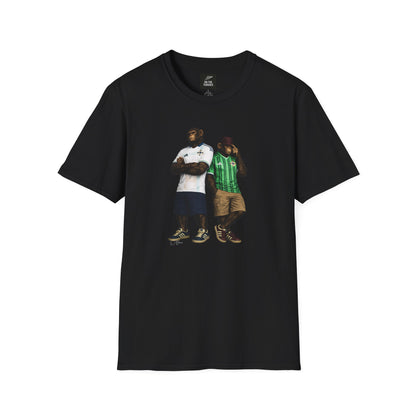 A black short-sleeved t-shirt featuring a central graphic of two chimpanzees styled as Northern Ireland national team supporters. The chimpanzee on the left stands with arms crossed, wearing a white away jersey with blue trim and the Northern Ireland crest. The chimpanzee on the right wears the classic green home jersey with vertical stripes, khaki cargo shorts, and a maroon bucket hat