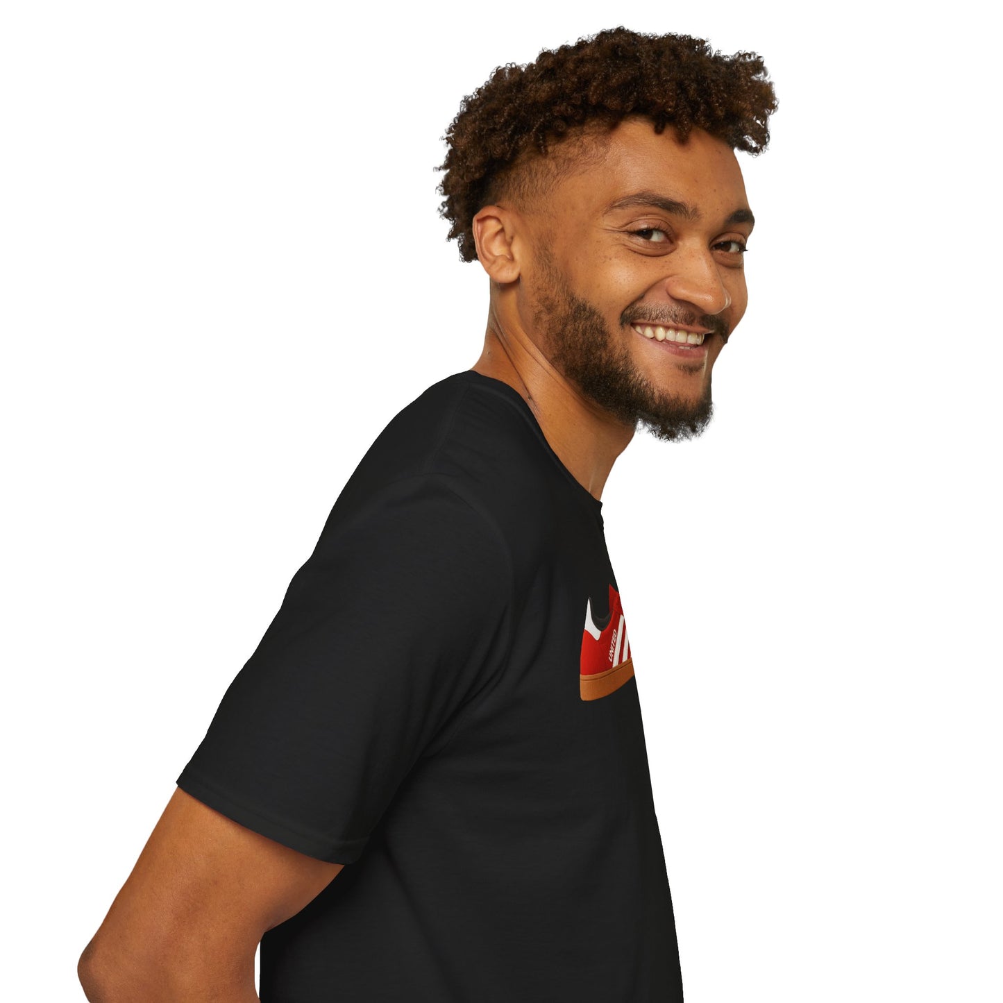 Smiling man with curly hair wearing a black t-shirt with red sneaker graphic on white background
