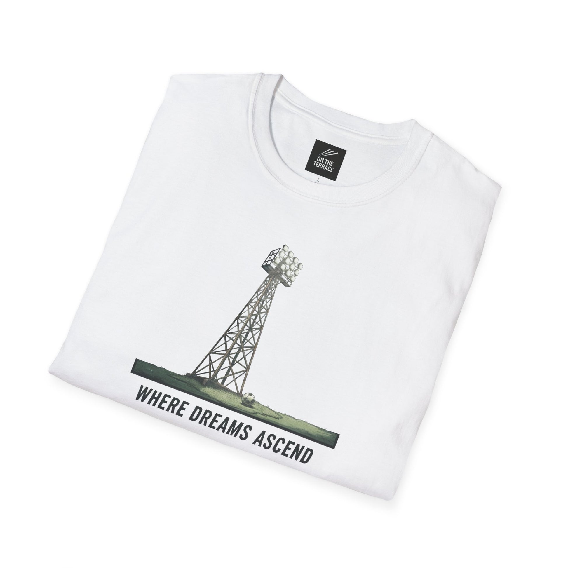 White folded t-shirt with graphic of a stadium floodlight tower and text 'Where Dreams Ascend'