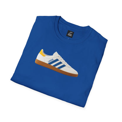 Leeds United Blue t-shirt with graphic of white and blue sneaker labeled Leeds and yellow heel detail