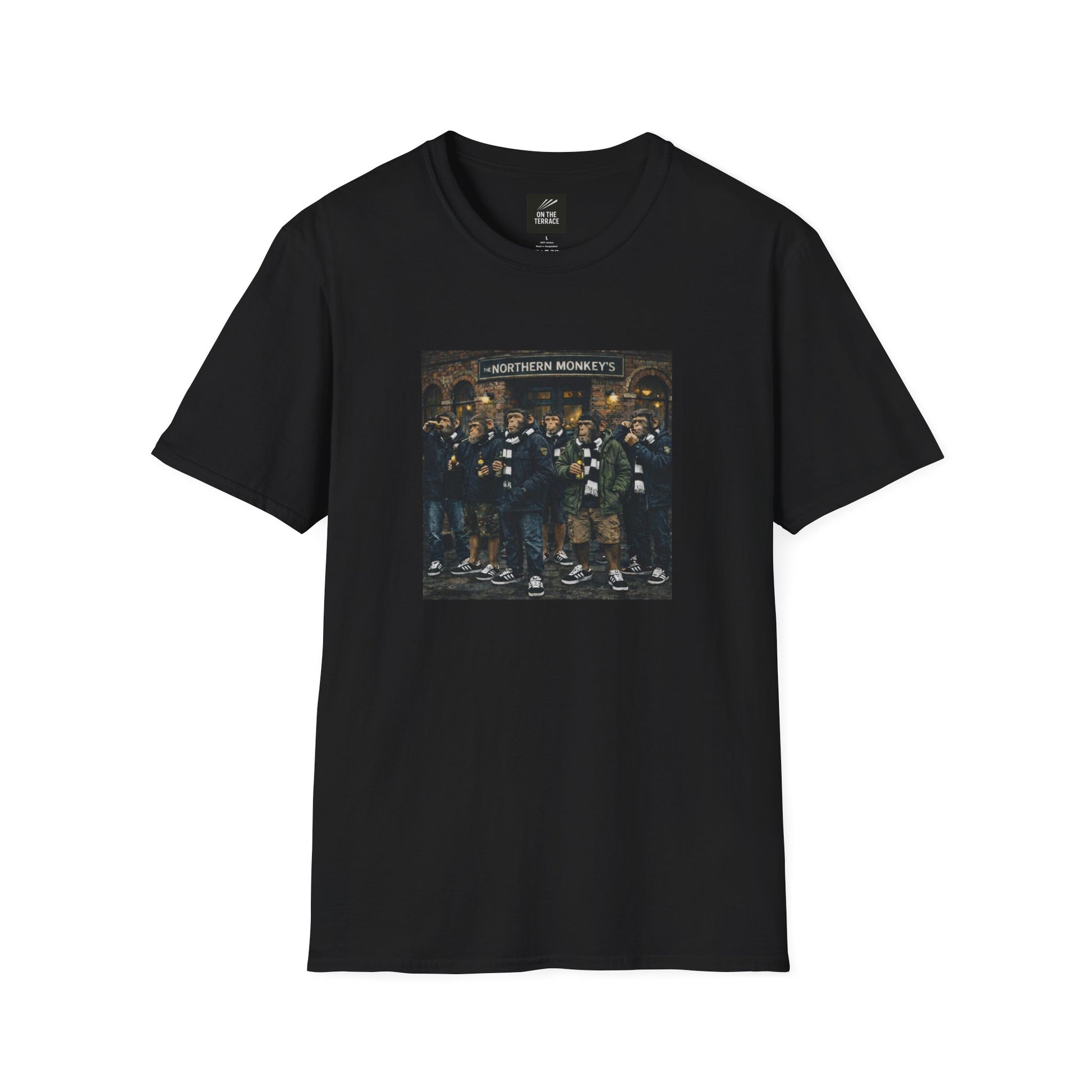 A black, short-sleeved crewneck t-shirt featuring a large, colorful rectangular graphic on the chest. The artwork depicts a group of seven chimpanzees standing in front of a traditional brick pub with a sign that reads "THE NORTHERN MONKEY'S". The monkeys are dressed in classic British "terrace culture" or "football casual" fashion, wearing olive and navy parkas, puffer jackets, black-and-white striped scarves, and black  trainers with white stripes. Some of the figures are shown holding bottles.