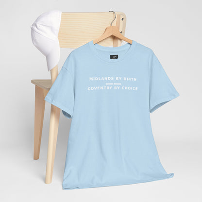 Sky blue Midlands By Birth, Coventry By Choice T-shirt hanging by a wooden chair