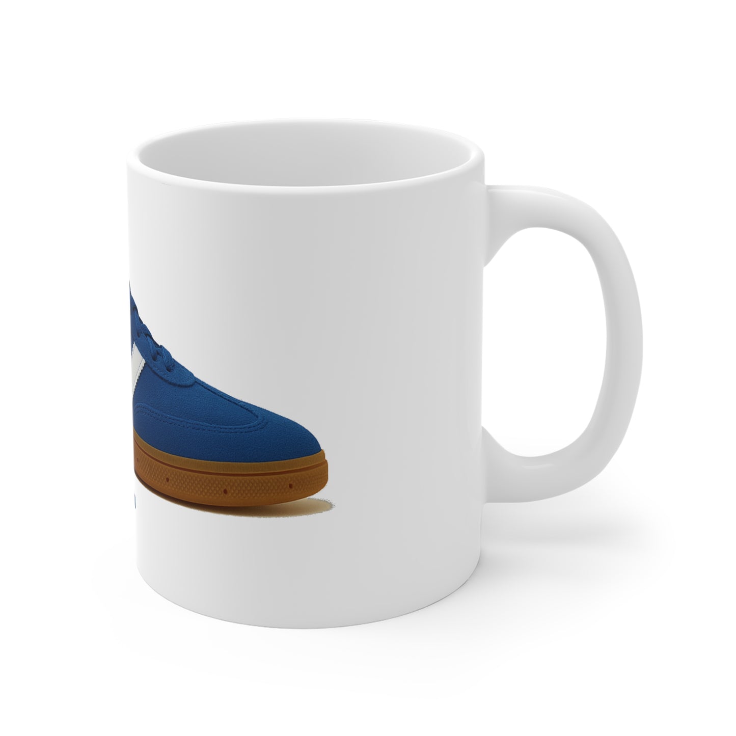 White ceramic mug with a blue sneaker and gum sole printed on side against white background