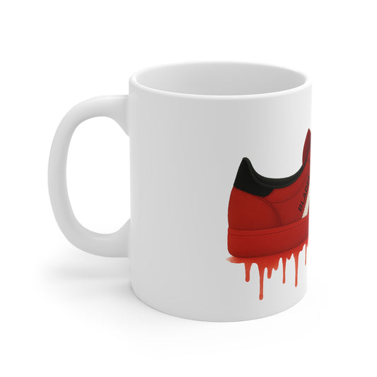 White ceramic mug with red and black sneaker design and red paint drip effect
