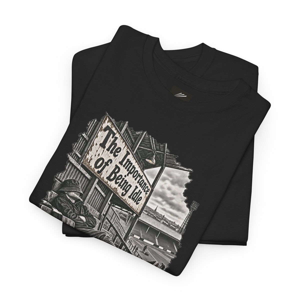 Folded black Oasis-inspired T-shirt showing The Importance of Being Idle sign graphic