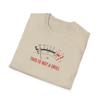 Beige graphic t-shirt with VU meter and 'This Is Not A Drill' slogan, folded on white background.