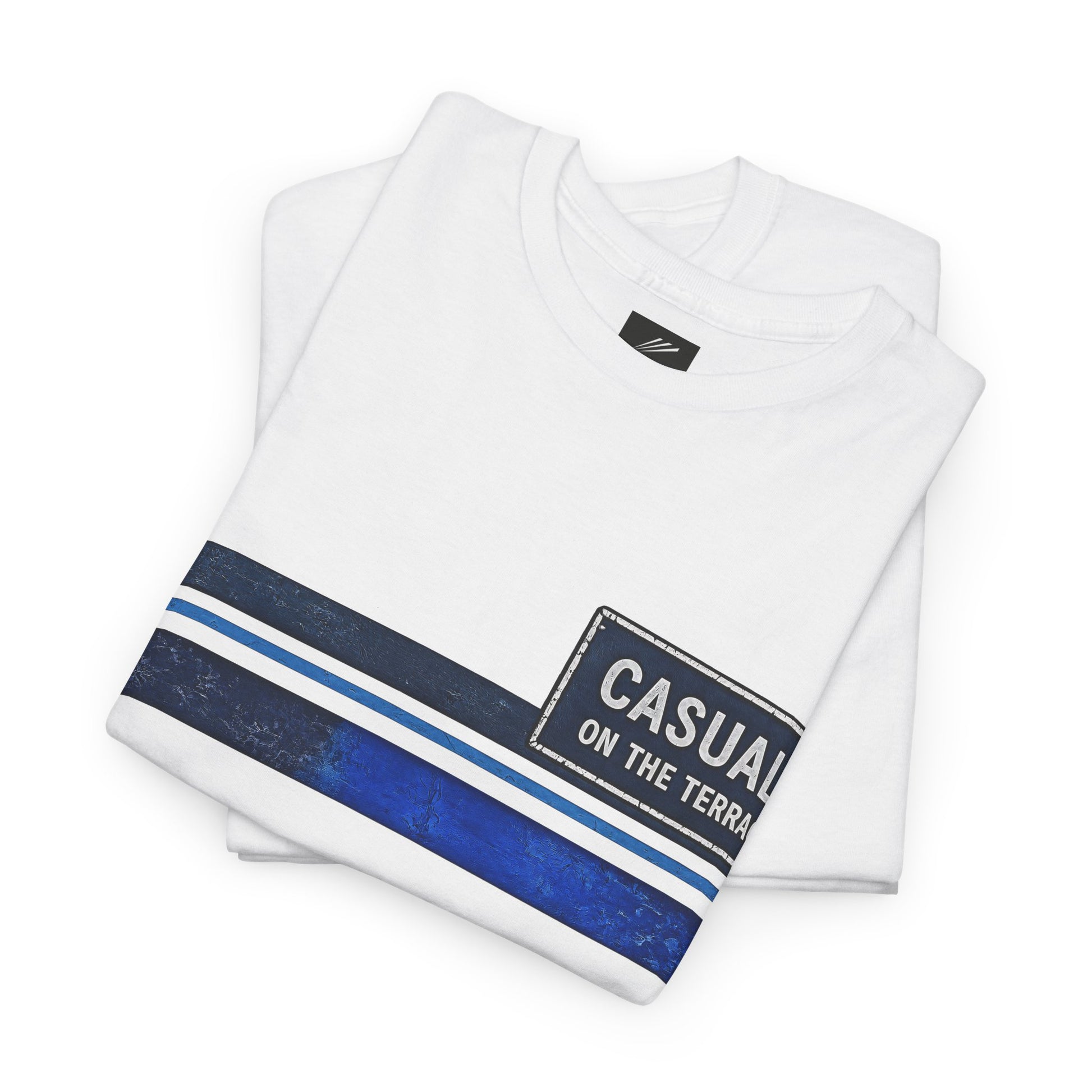 A folded white short-sleeve t-shirt with a graphic design. The design features a dark navy blue and light blue horizontal stripe pattern on the lower left, alongside a distressed black rectangular patch with the text 'CASUAL ON THE TERRACE' in white.