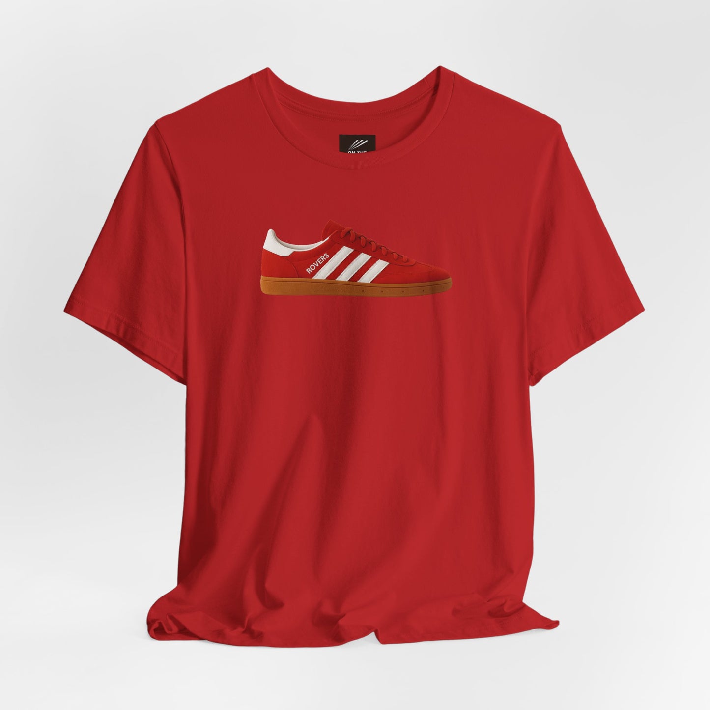 Red t-shirt with graphic of red sneaker featuring white stripes and gum sole