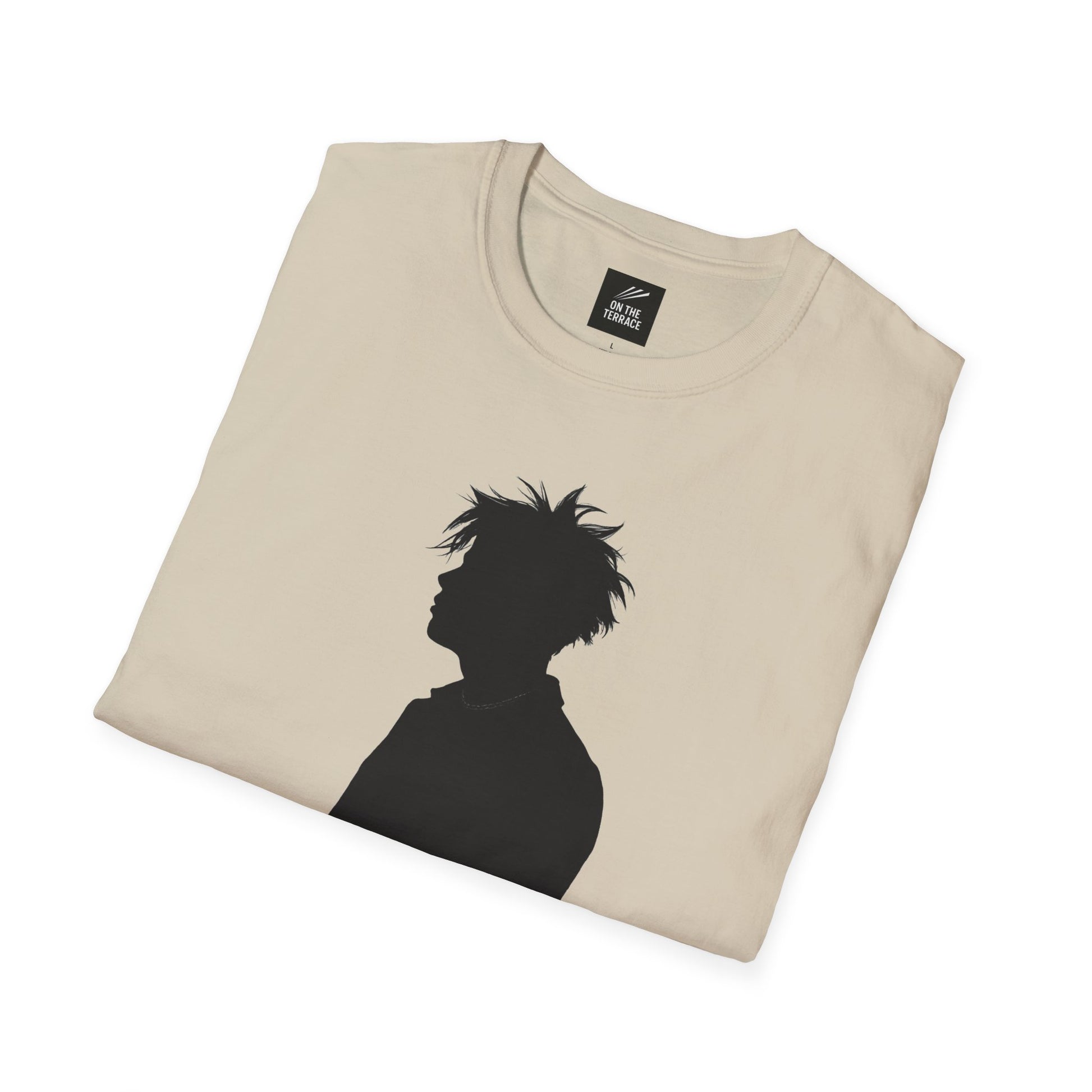 Folded beige t-shirt with black silhouette graphic of a person with messy hair and necklace