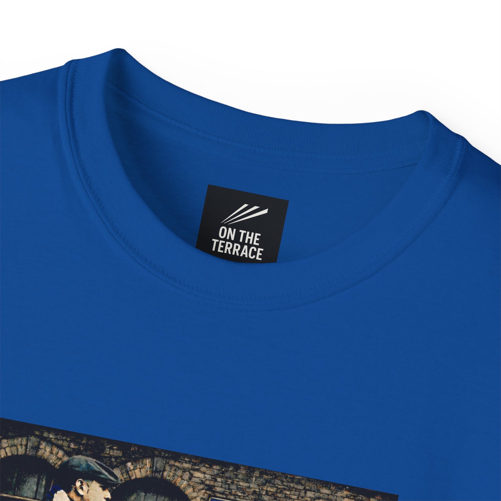Blue t-shirt with 'On The Terrace' label on a white background