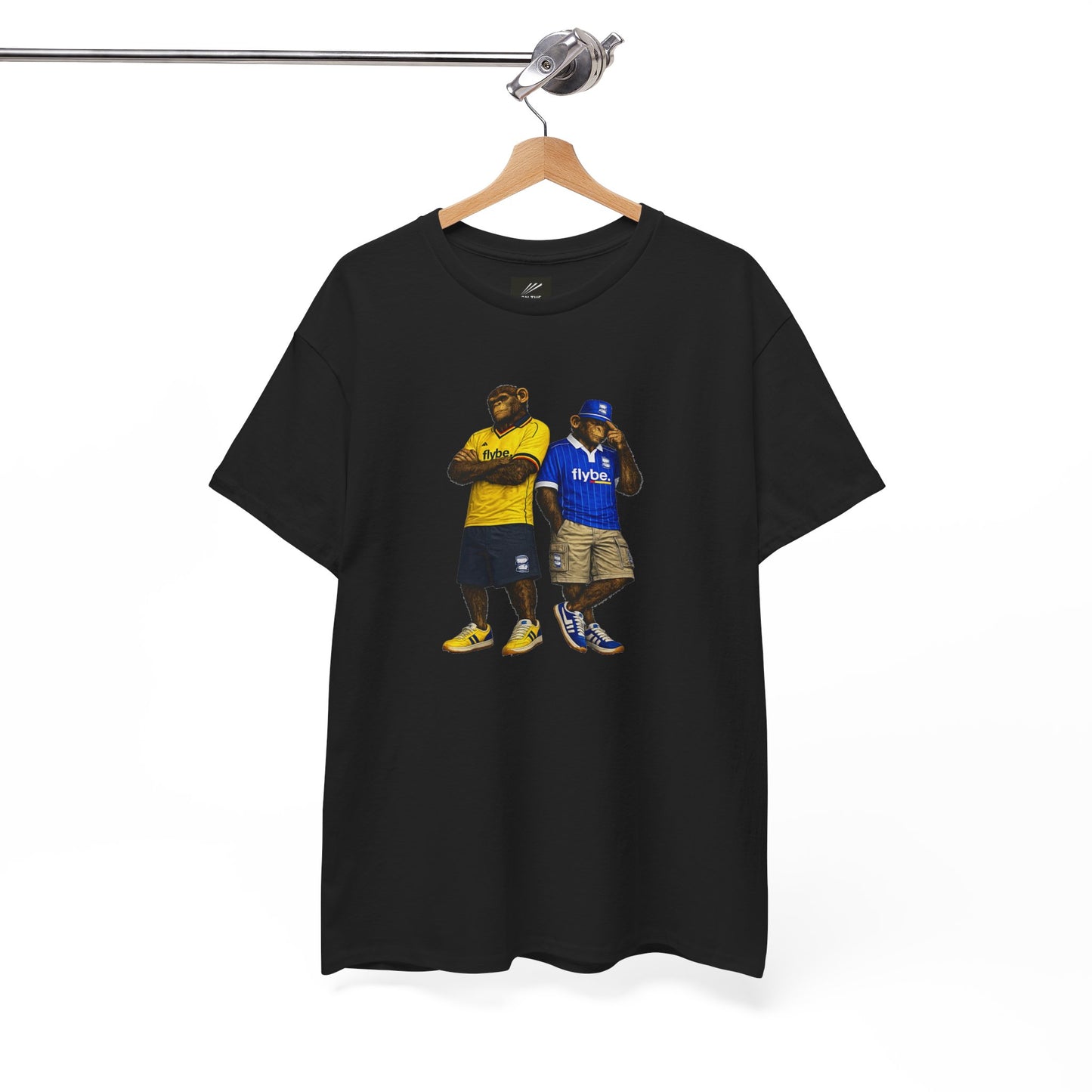 A black short-sleeve Birmingham t-shirt hanging on a wooden hanger from a metal rack, featuring a graphic print of two hip-hop style figures wearing yellow and blue jerseys.