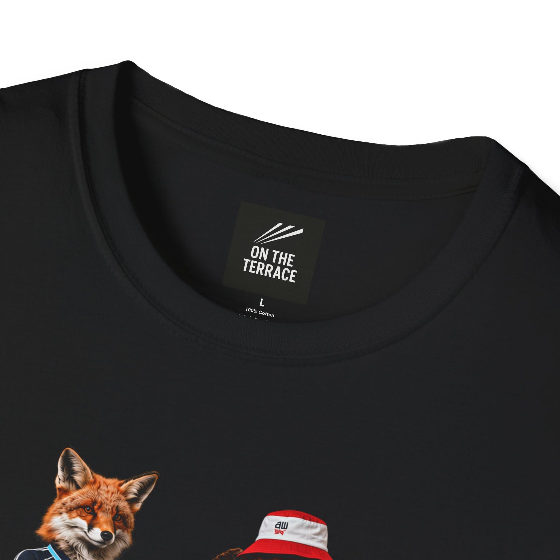 A black graphic t-shirt laid flat, featuring a central design by On The Terrace for Bolton fans. The graphic showcases two anthropomorphic English foxes dressed in vintage Rbk Bolton-inspired football kits. The fox on the left wears the dark blue retro away jersey with arms crossed, while the fox on the right sports the classic white home shirt, a red and white bucket hat, and cargo shorts. The inner neck of the tee features the official "On The Terrace" brand logo