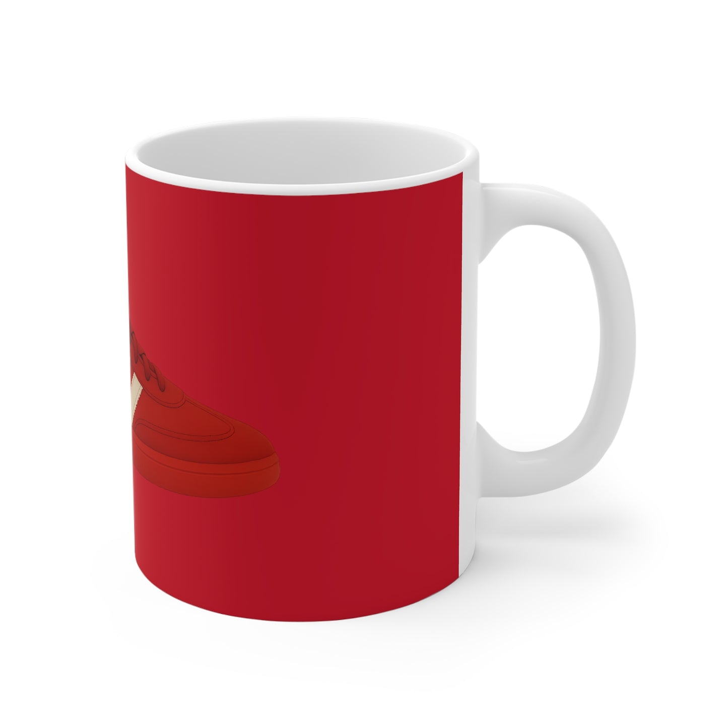 White ceramic mug with red exterior and glossy shoe graphic on side