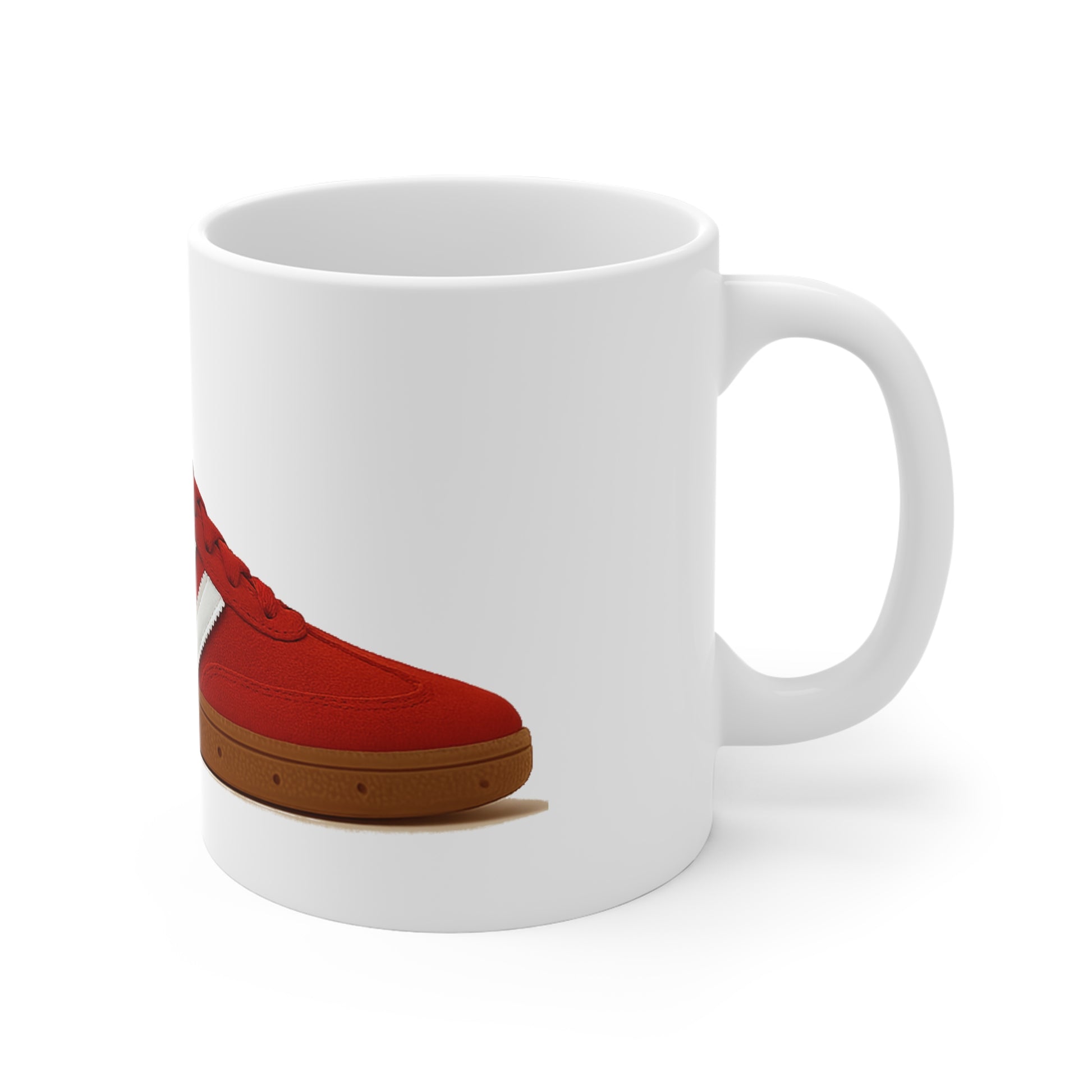 White ceramic coffee mug with a red sneaker graphic and brown sole on the side