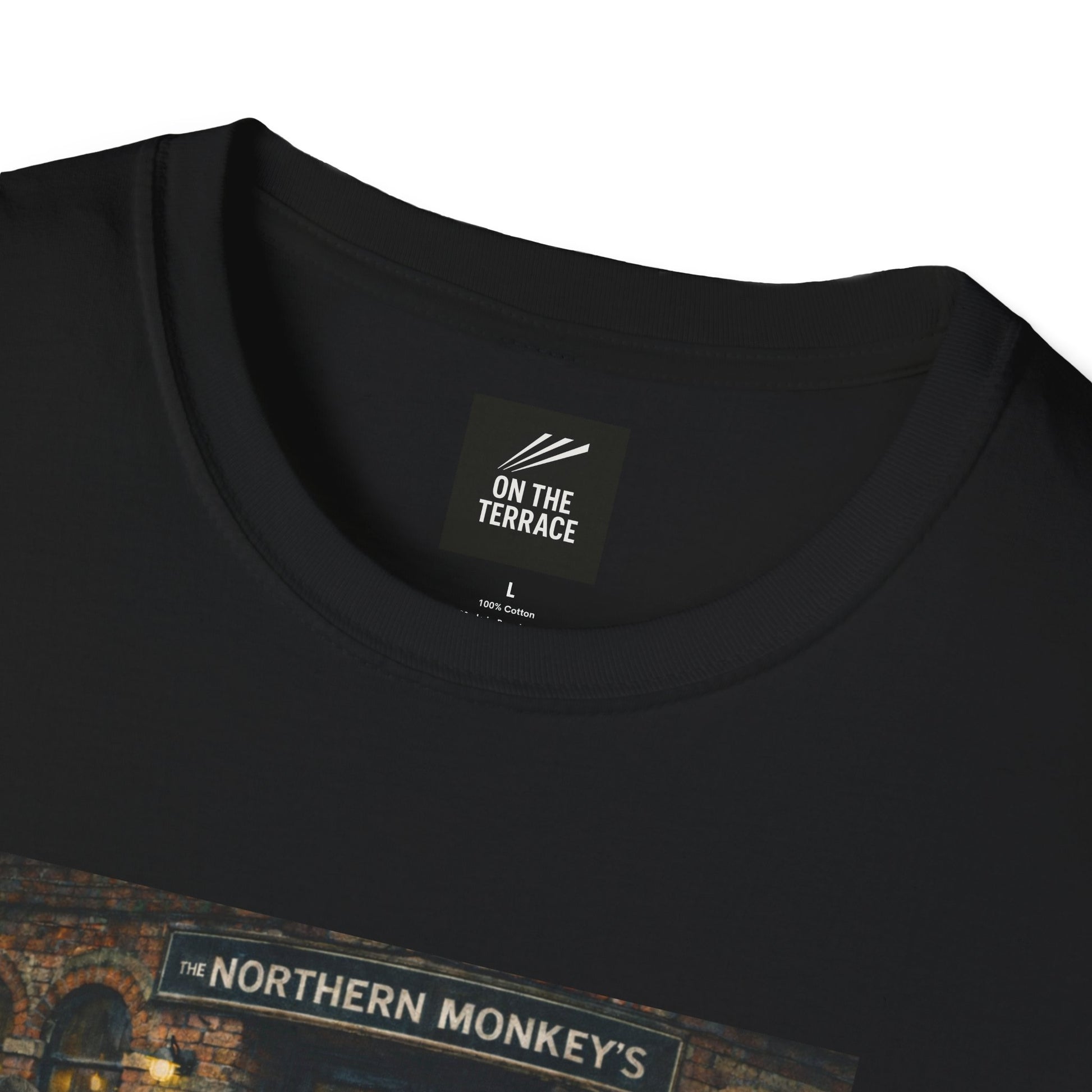close up of a Black t-shirt with a graphic of chimpanzees dressed as Manchester City fans in scarves and parkas standing outside a pub called "The Northern Monkey's."