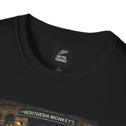 close up of a Black t-shirt with a graphic of chimpanzees dressed as Manchester City fans in scarves and parkas standing outside a pub called "The Northern Monkey's."