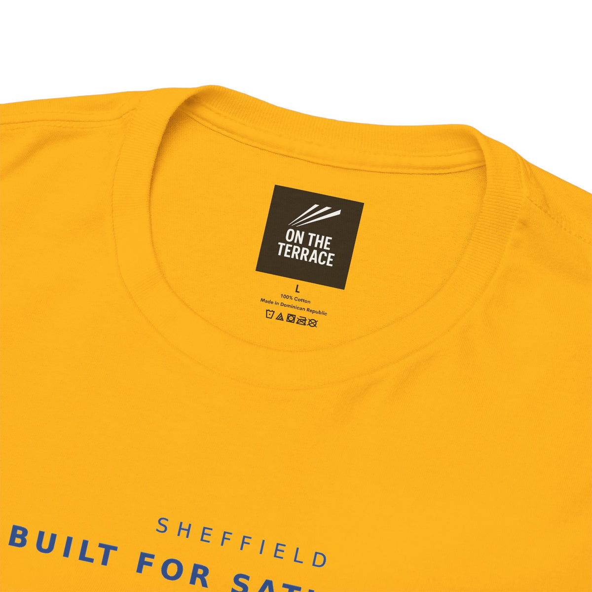 Close-up of On The Terrace neck label and navy lettering on gold tee