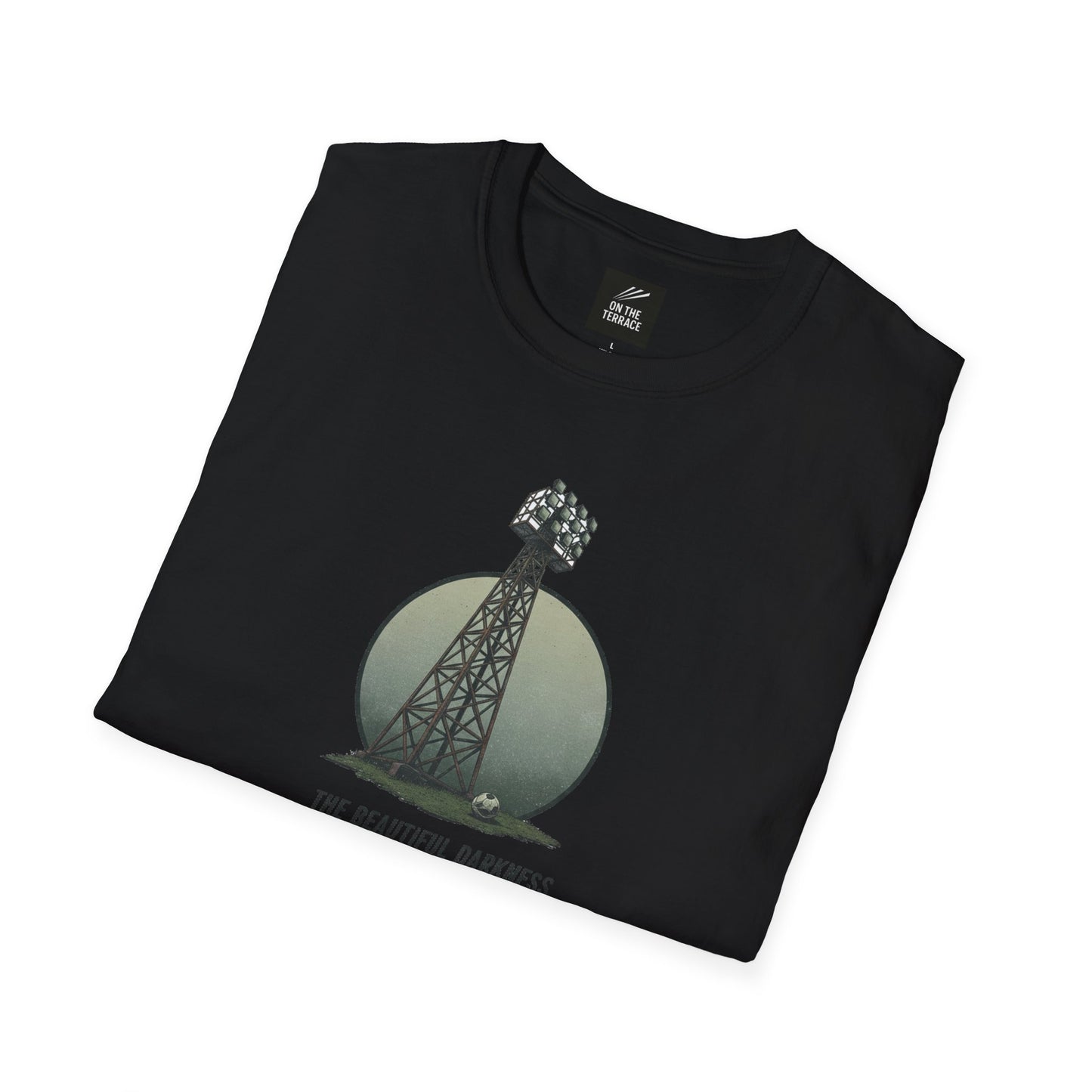 Black folded t-shirt with a graphic of a stadium floodlight tower and a soccer ball on grass