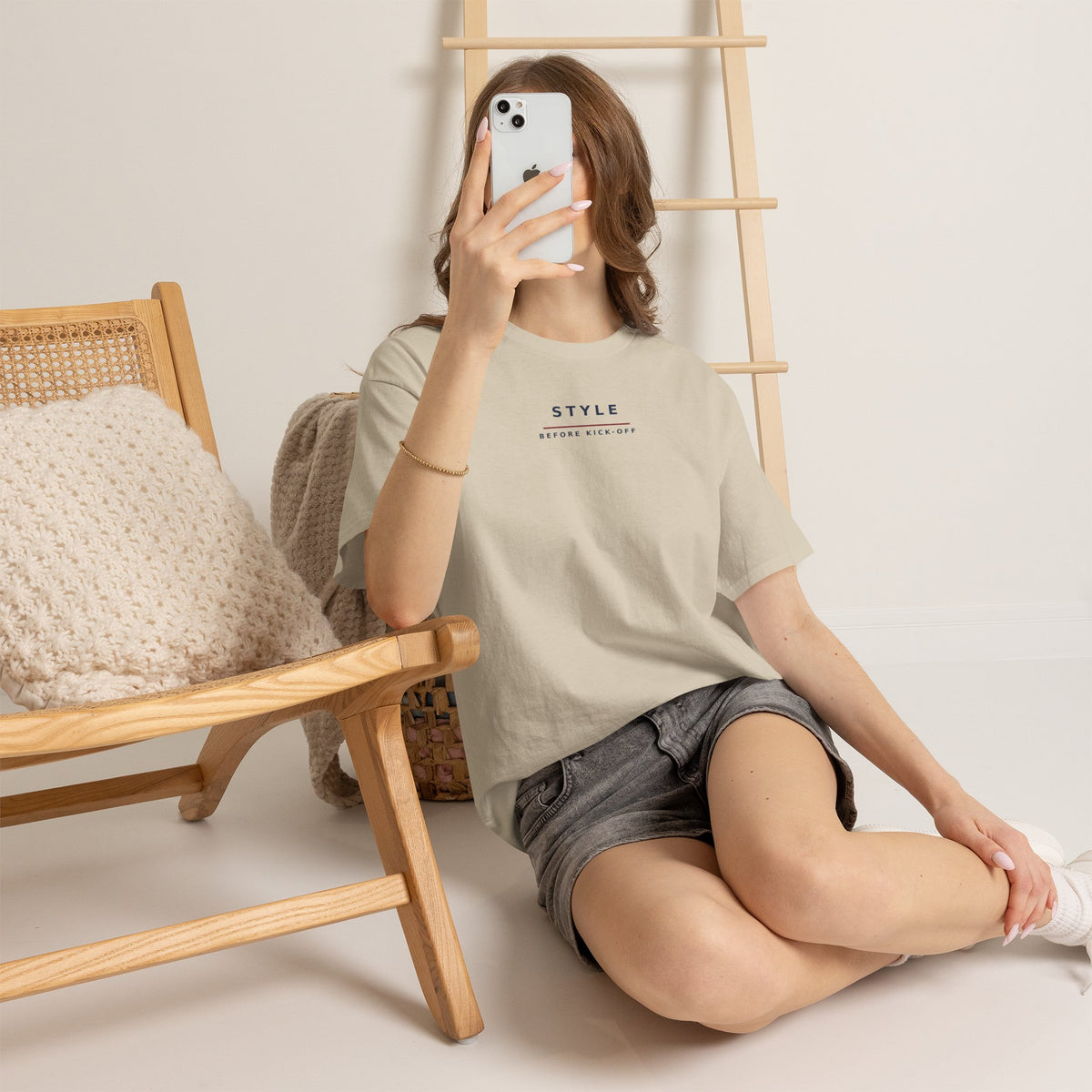 Woman sitting on the floor taking a mirror selfie in the sand Style Before Kick-Off tee