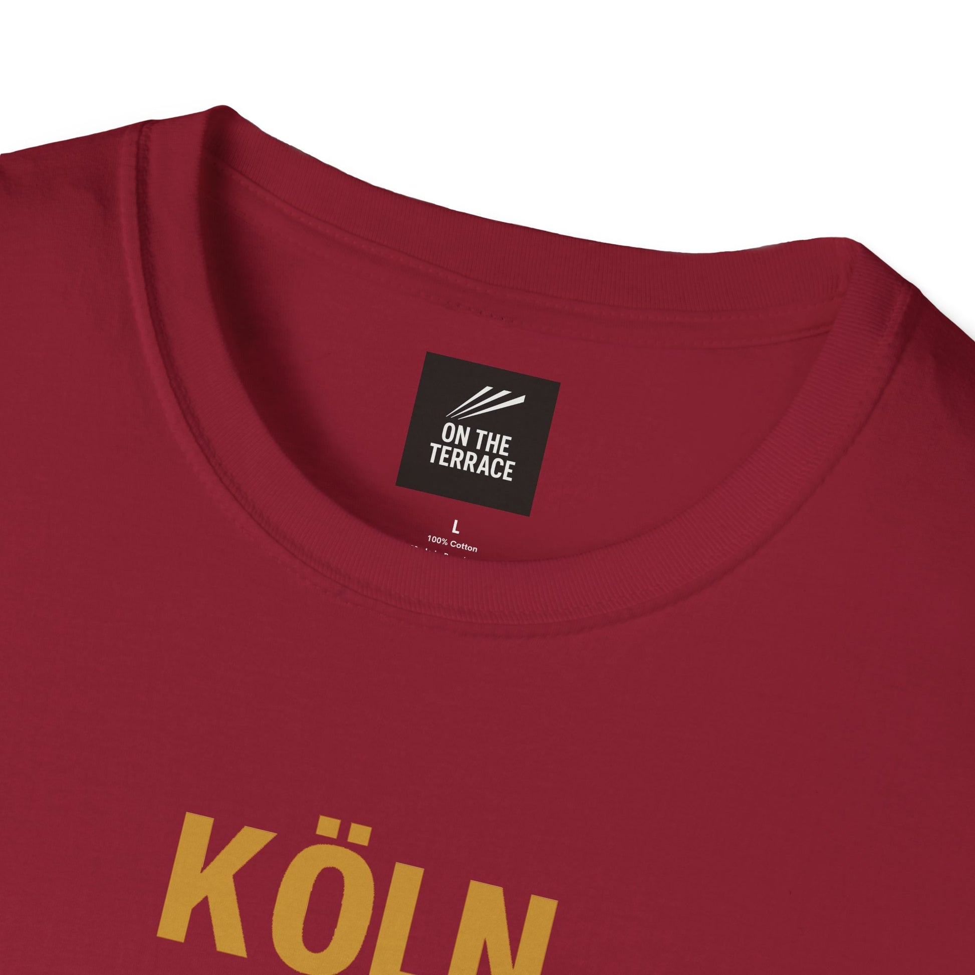 Close-up of maroon cotton t-shirt with yellow text 'KÖLN' and On The Terrace brand label inside collar
