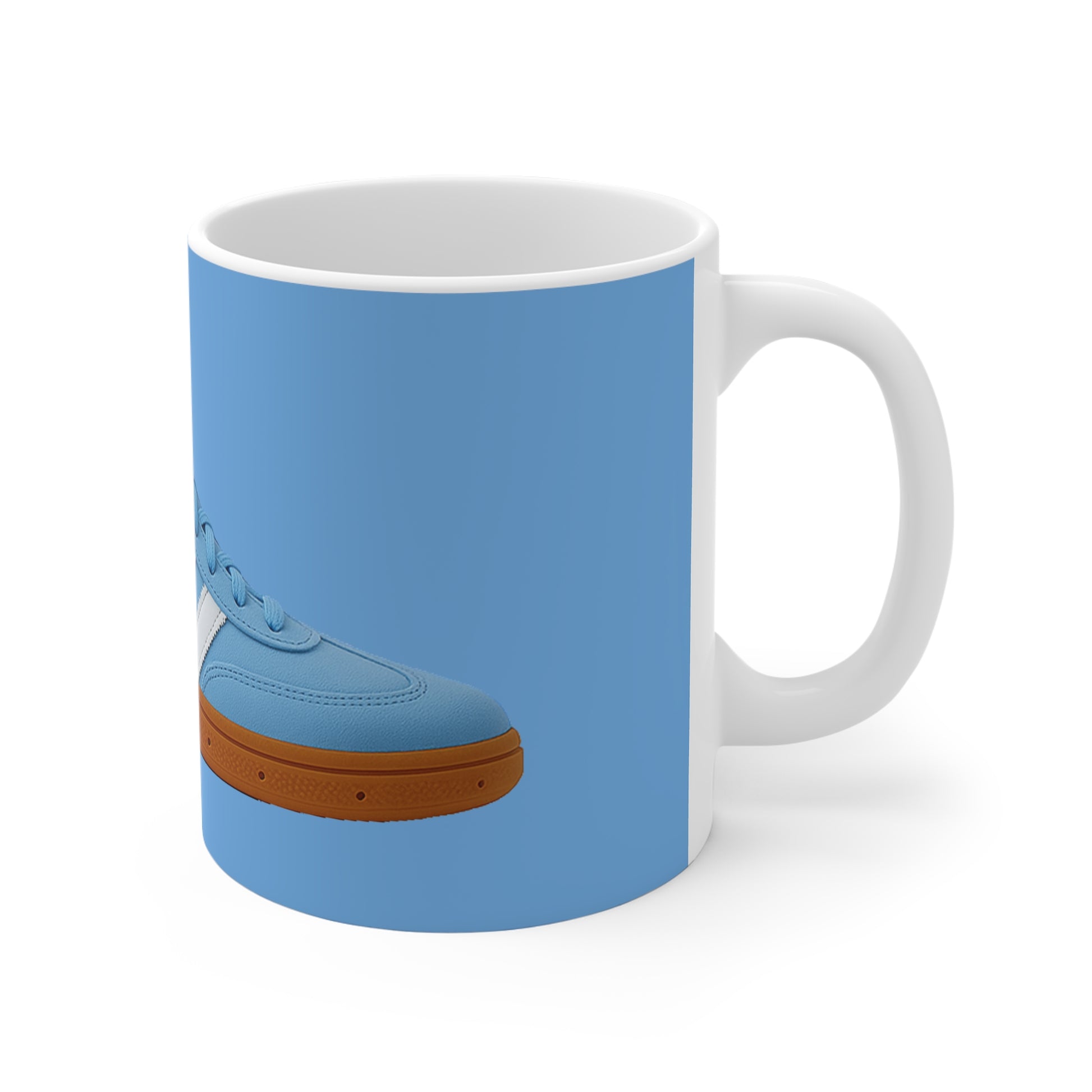 White ceramic mug with blue sneaker design featuring brown sole and white stripes