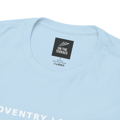 Close-up of the neck label and COVENTRY LOYALTY print on the sky blue tee