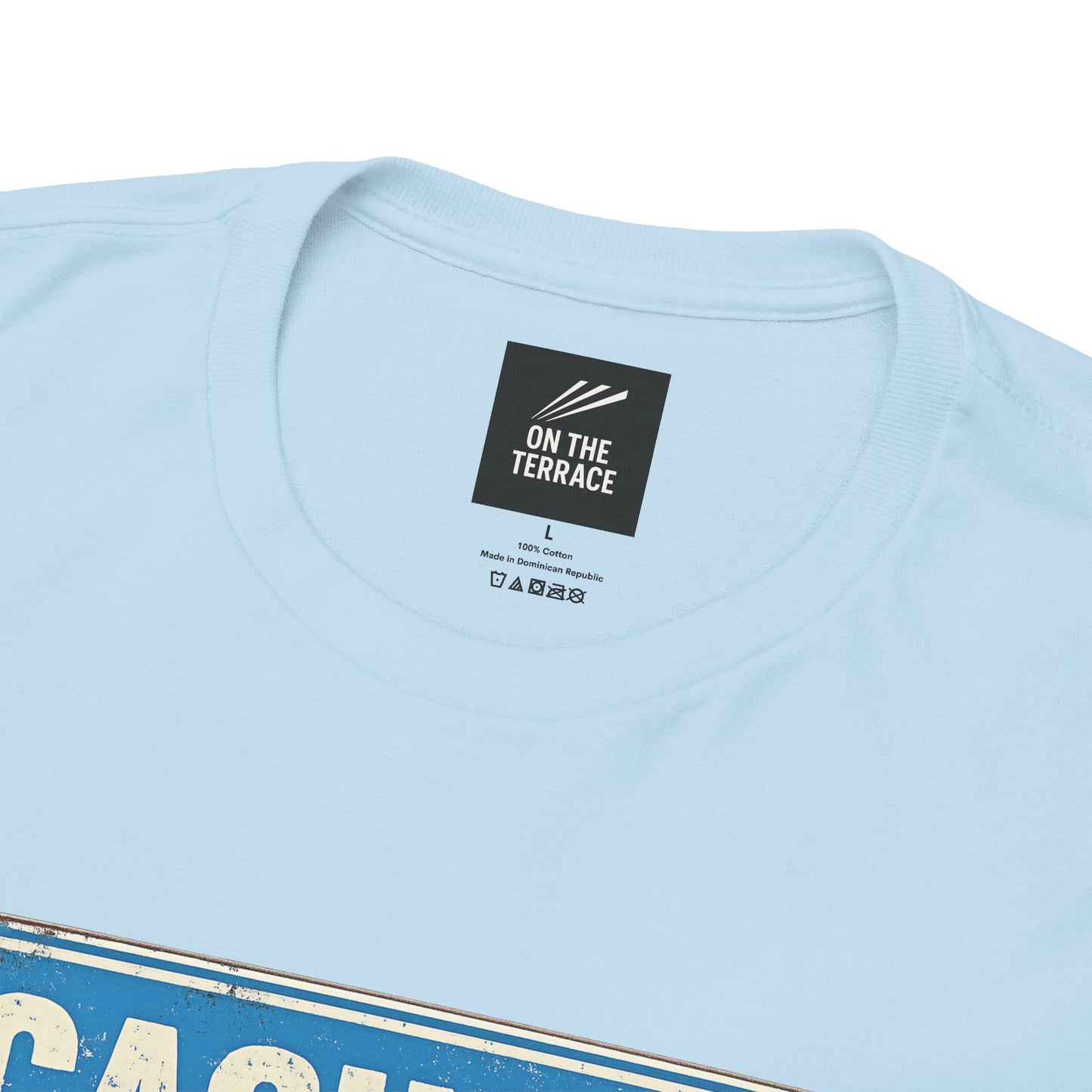 Close-up of a light blue MCFC t-shirt showing the inner neck label which reads 'ON THE TERRACE'.